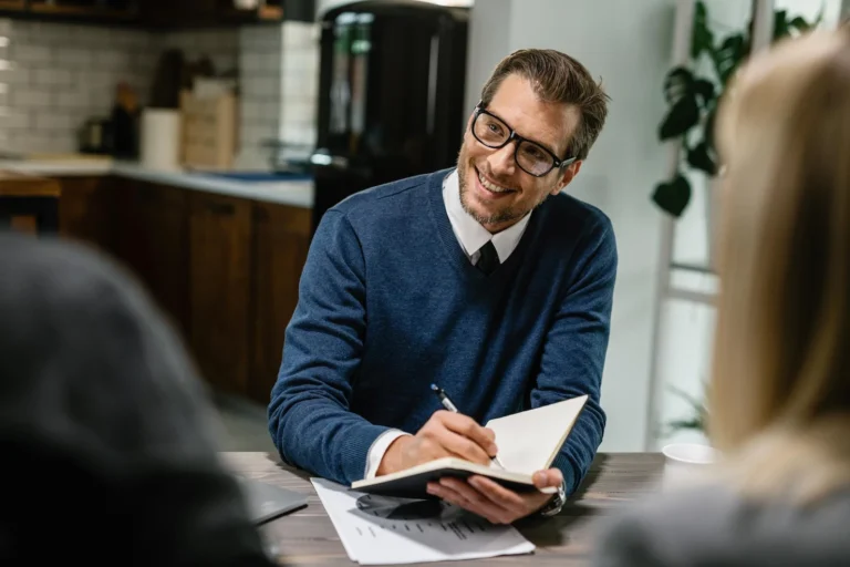 happy-financial-advisor-communicating-with-couple-
